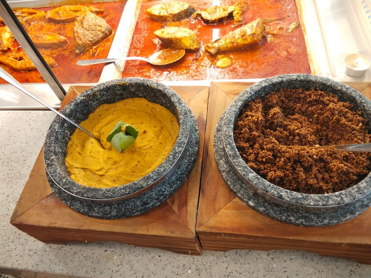 Curries and sambal in stone bowls