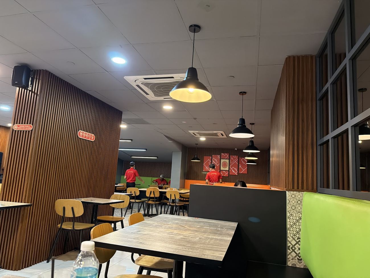Dining hall with red pitch panels and booths